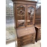 AN ARTS AND CRAFTS STYLE OAK BUREAU BOOKCASE WITH FALL FRONT, THREE DRAWERS AND TWO UPPER LEAD