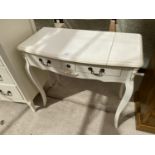 A CREAM DRESSING TABLE WITH TWO DRAWERS