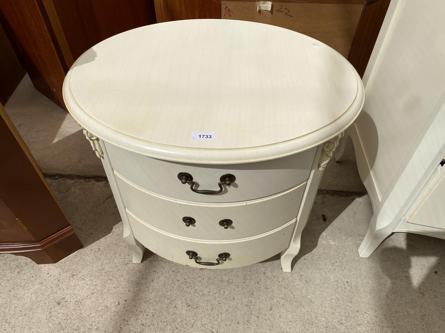 AN OVAL BEDROOM CHEST OF THREE DRAWERS