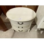 AN OVAL BEDROOM CHEST OF THREE DRAWERS