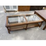 A MAHOGANY COFFEE TABLE WITH GLASS TOP