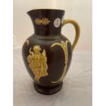 A BROWN GLAZED AND SLIPWARE VICTORIAN JUG