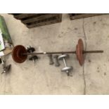 A WEIGHT LIFTING BAR AND DUMB BELLS