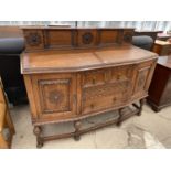 A CARVED OAK SIDEBOARD WITH TWO DOORS AND TWO DRAWERS