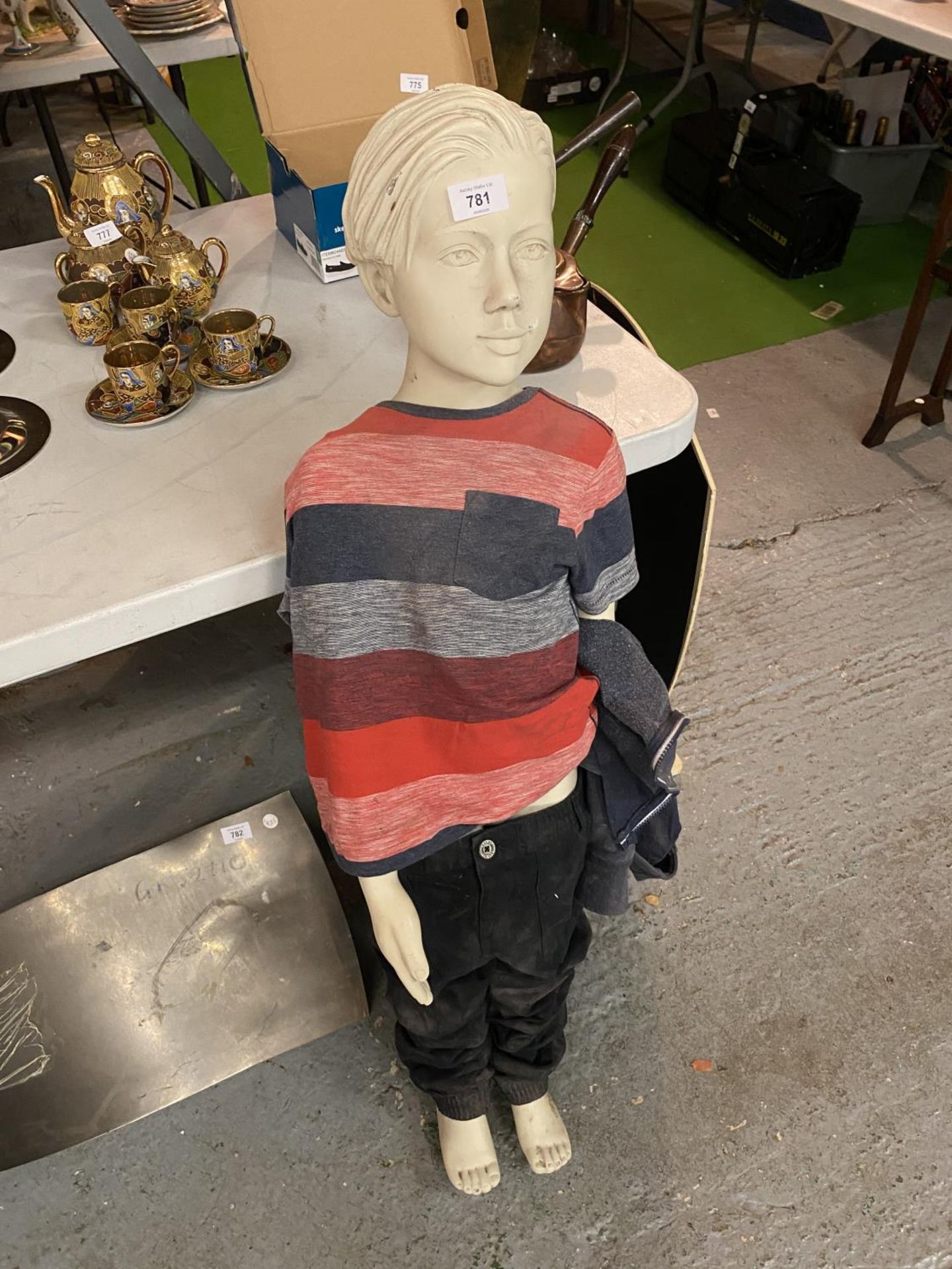 A TALL CLOTHED MODEL OF A YOUNG BOY