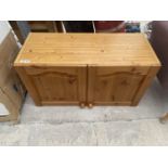 A PINE CABINET WITH TWO DOORS