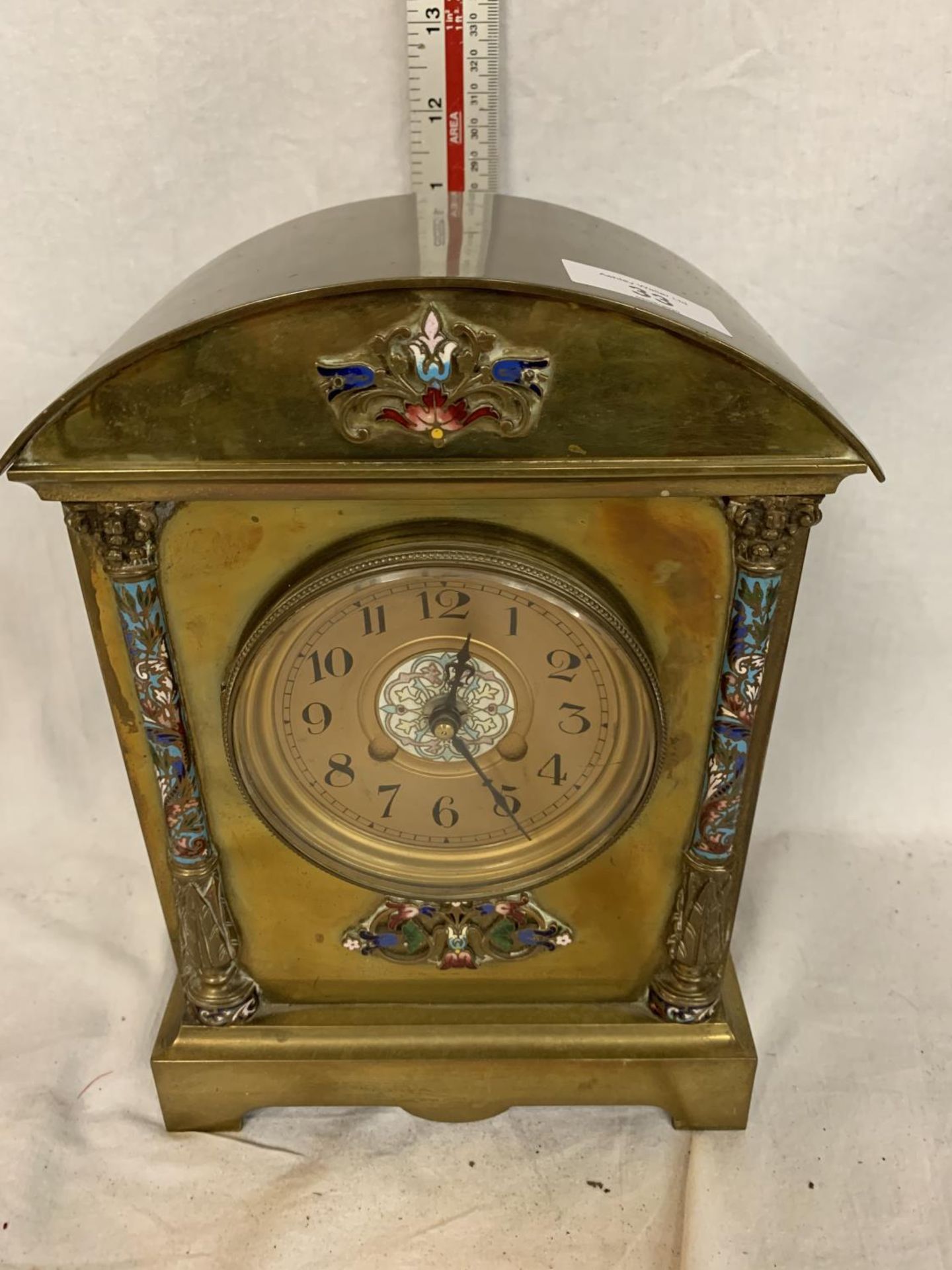 A LATE 19TH CENTURY BRASS CLOCK MOUNT AND DIAL WITH ART NOUVEAU COLOURED FLORAL ENAMEL DECORATION