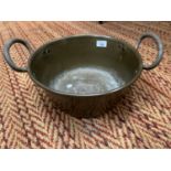 A LARGE METAL TWO HANDLED PAN