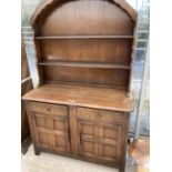 A PRIORY STYLE OAK DRESSER WITH TWO DOORS, TWO DRAWERS AND UPPER PLATE RACK