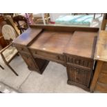 AN OAK DESK WITH SEVEN DRAWERS