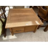 A MODERN OAK COFFEE TABLE WITH TWO DRAWERS