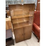 A TEAK BOOKCASE CABINET WITH TWO LOWER DOORS AND FOUR SLIDING GLASS DOORS