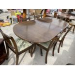 AN EXTENDING MAHOGANY DINING TABLE AND SIX CHAIRS