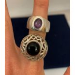 TWO DESIGNER RINGS WITH DARK COLOURED STONES