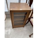 A SMALL OAK CABINET WITH SINGLE GLAZED DOOR AND INNER SHELVING