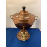 A BRASS AND COPPER TWIN HANDLED URN