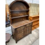 A PRIORY OAK WELSH DRESSER WITH TWO DOORS, TWO DRAWERS AND PLATE RACK WITH ARCHED TOP