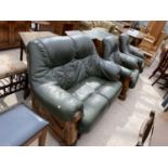 AN OAK AND LEATHER TWO SEATER SOFA, TWO ARMCHAIRS AND A FOOT STOOL