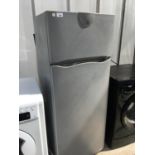 AN INDESIT UPRIGHT FRIDGE FREEZER, SHELF MISSING, DOOR COMPARTMENT MISSING, NEEDS A CLEAN