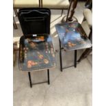 A JAPANNED SET OF FOUR ORIENTAL DESIGN FOLDING OCCASIONAL TABLES
