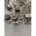 SEVEN ASSORTED SILVER TOPPED INK WELLS