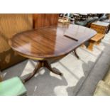 A MAHOGANY EXTENDING DINING TABLE ON TWIN PEDESTAL SUPPORTS