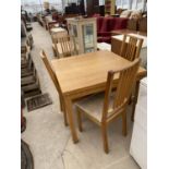 AN OAK DINING TABLE AND FOUR CHAIRS