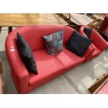 A RETRO STYLE TWO SEATER TUB SOFA AND ARMCHAIR