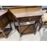 A CARVED OAK CANTED HALL TABLE WITH ONE DRAWER