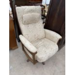 AN ERCOL GOLDEN DAWN ELM ARMCHAIR ON SWIVEL SUPPORT