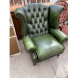 A GREEN LEATHER WING AND BUTTON BACK ARMCHAIR