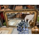 AN ORNATE BLACK AND GOLD COLOUR FRAMED MIRROR