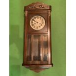 A VINTAGE WOODEN CASED WALL CLOCK