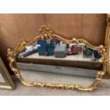 AN ORNATE GILT FRAMED MIRROR 123CM WIDE