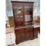 A MAHOGANY BOOKCASE CABINET WITH TWO DOORS, TWO DRAWERS AND TWO UPPER GLAZED DOORS