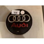 A SMALL VINTAGE STYLE CIRCULAR CAST AUDI SIGN