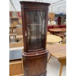 A MAHOGANY CORNER CABINET WITH LOWER DOOR AND UPPER GLAZED PANEL DOOR