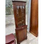 A MAHOGANY CORNER CABINET WITH LOWER DOOR AND UPPER GLAZED PANEL DOOR