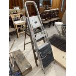 A VINTAGE SET OF WOODEN STEP LADDERS AND TWO ALLOY STEP LADDERS
