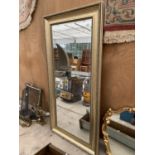 A LARGE RECTANGUALR FRAMED MIRROR