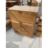 AN ERCOL ELM COCKTAIL CABINET WITH FALL FRONT, TWO DOORS AND ONE DRAWER