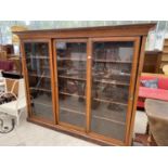 A LARGE MAHOGANY BOOKCASE CABINET WITH THREE SLIDING GLASS DOORS