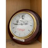 A WOODEN FRAMED GUINESS WALL CLOCK