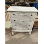 A WHITE CHEST OF FOUR DRAWERS