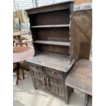 A PRIORY STYLE OAK DRESSER WITH TWO DOORS, TWO DRAWERS AND UPPER PLATE RACK