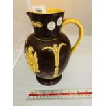 A BROWN GLAZED AND SLIPWARE VICTORIAN JUG