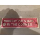 A SMALL VINTAGE STYLE REPRODUCTION CAST METAL NOBODY PUTS BABY IN THE CORNER SIGN