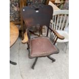 AN EARLY 20TH CENTURY OAK STUDY CHAIR (MISSING ONE CASTER)