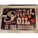 A VINTAGE STYLE TIN SMELL OF OIL METAL SIGN