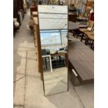 A TALL TEAK MIRROR